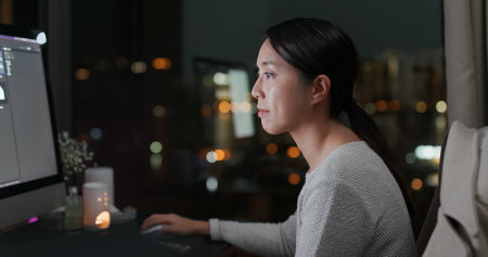 Woman working on computer at night