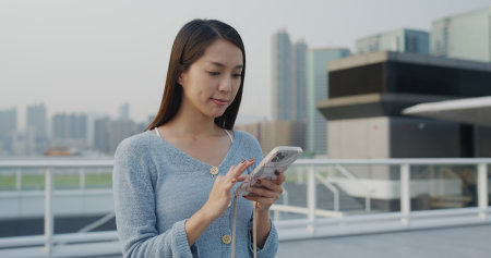 Woman use cellphone to take photo in Hong Kong