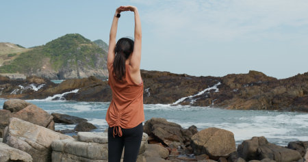 Woman stretching at seaside