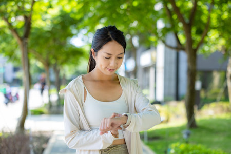 Woman does exercise with her smart watchの写真素材