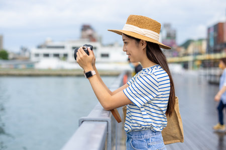 Travel woman take photo on camera in the city