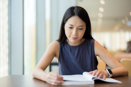 Woman read a book in library