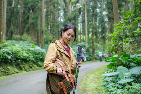 Hiker woman find something inside her backpackの写真素材