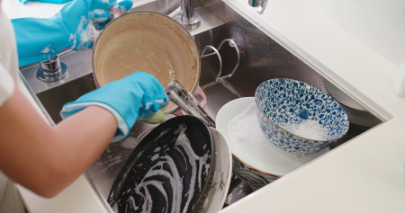 Woman wash dishes in the kitchen