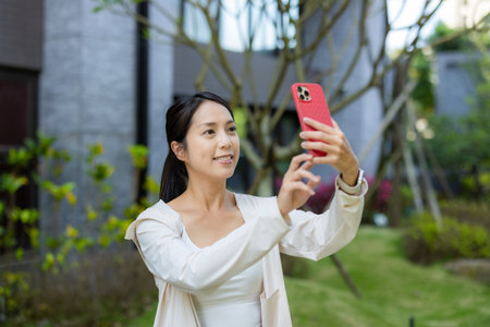 Woman use cellphone to take photoの写真素材