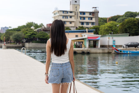 Woman walk along the river side at Tamsui