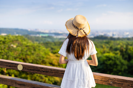 Woman enjoy the city view mountainの写真素材