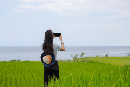 Tourist woman use cellphone to take photo in countrysideの写真素材