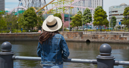 Woman look around the city view in yokohamaの写真素材
