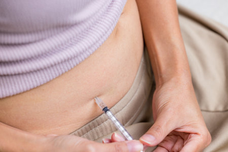 IVF and infertility treatment concept, woman have injection on her bellyの写真素材