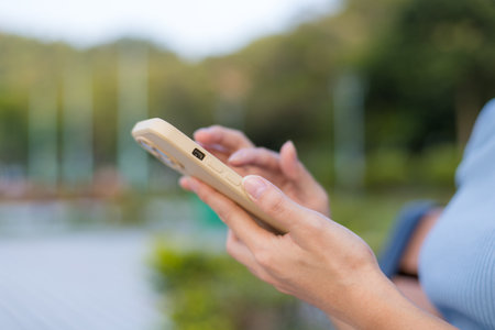 Woman use mobile phone at outdoorの写真素材