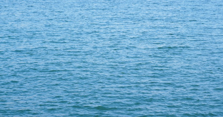 Sea surface water with sunlight sparkleの写真素材