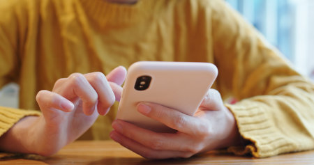 Woman use of cellphone at coffee shopの写真素材