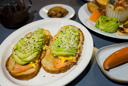 Sliced avocado on salmon toast bread with spicesの写真素材