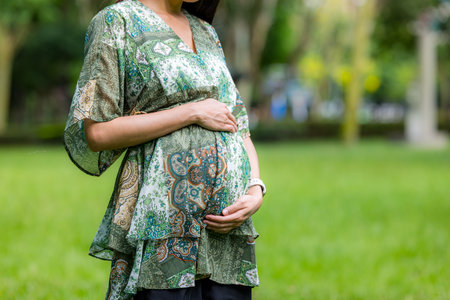 Pregnant woman with the green park gardenの写真素材