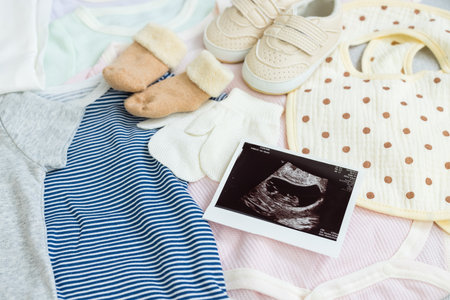 Ultrasound photo with baby clothingの写真素材