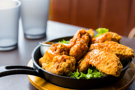 Deep fried chicken wing in restaurantの写真素材