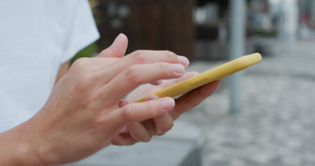 Woman use smart phone at outdoorの写真素材