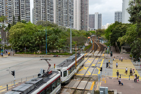 Hong Kong 03 April 2024: Hong Kong residential district at Tin Shui Wai with light railの写真素材