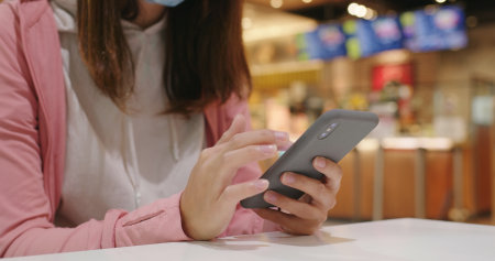 Woman use smart phone at restaurantの写真素材