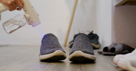 UV Light alcohol spray for cleaning pair of shoesの写真素材