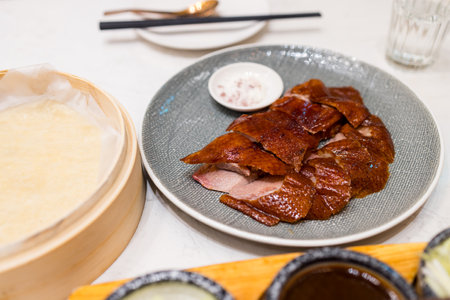 Peking duck slice of roasted duck on the plate at restaurantの写真素材