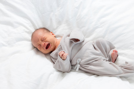 Newborn baby cry on the bed