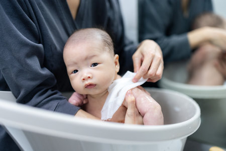 Newborn baby take bath in the bathroom
