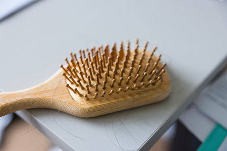 Wooden hair brush with fallen hair strandsの写真素材