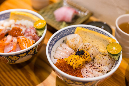 Colorful chirashi sushi with salmon shrimp scallop and uni