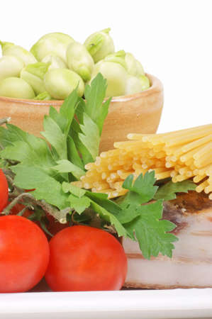 Ingredients to prepare spaghetti with broad beans, bacon, parsley and cherry tomatoes. Studio shot. の写真素材