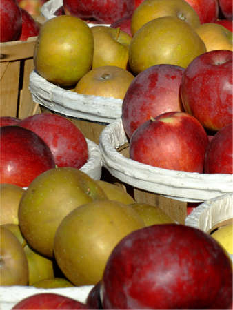 ripe apples in wood baskets for sale in a fruit and vegetables open market.の写真素材