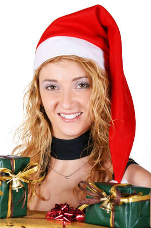 Beautiful young girl wearing Santa hat and holding presentsの写真素材