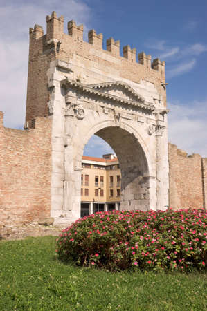 Arch of Augustus in Rimini. Built in 27 BC, it is the most ancient roman arch that still stands intact. The Ghibellines merlons at the top of the arch were built in the Middle Ages.の写真素材