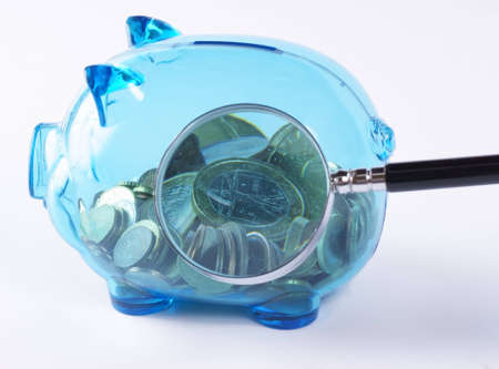 Magnified coins in a piggy bank. Studio shot.の写真素材