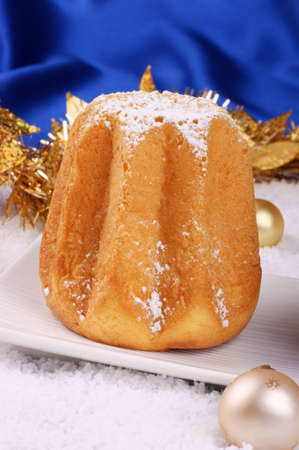 Christmas composition against a bright blue background: Pandoro, a typical italian Christmas cake, and Christmas decorationsの写真素材