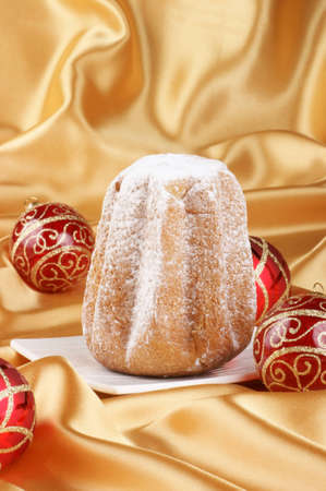 Christmas composition with Pandoro, the typical italian Christmas cake  Golden background with copy spaceの写真素材