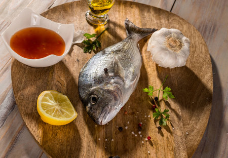 fish with vegetables on a stone slateの写真素材