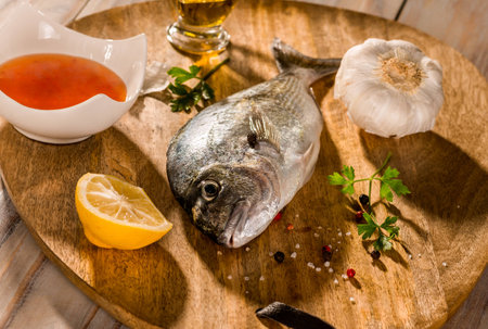 fish with vegetables on a stone slateの写真素材