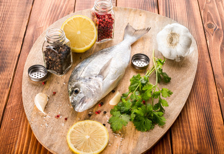 fish with vegetables on a wooden boardの写真素材