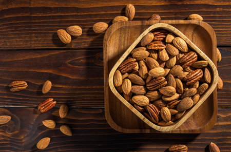 The nuts on a wooden background