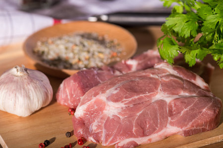 Pork steak on a cutting wooden boardの写真素材