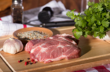 Pork steak on a cutting wooden boardの写真素材