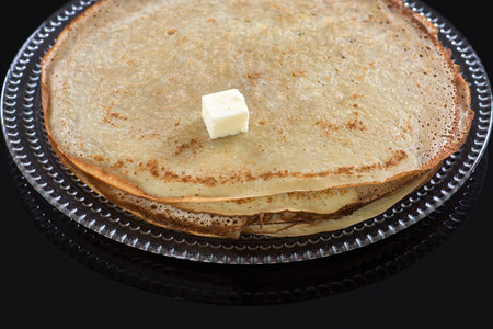 pancakes on the black glass backgroundの写真素材