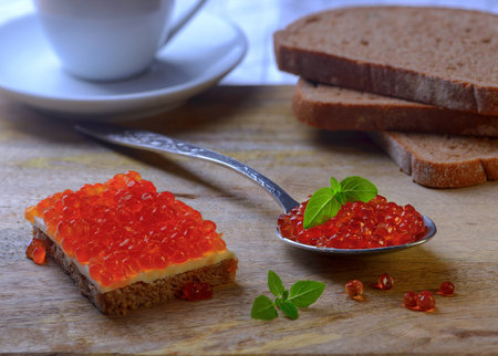 Sandwich with red caviar and on a metal spoonの写真素材