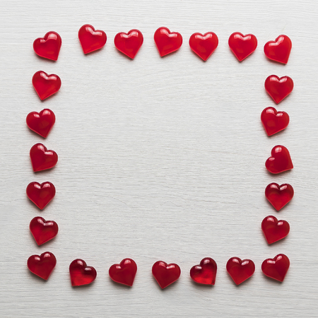 background of red hearts on a white wooden substrateの写真素材