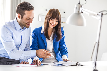 Young business people discussing together in officeの写真素材