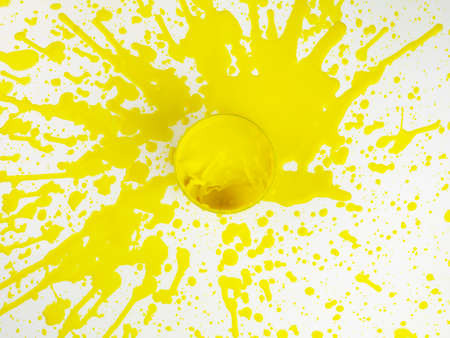 Splash of yellow paint from a bird's eye viewの写真素材