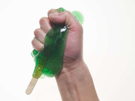 Melted ice lolly on a small woodenの写真素材