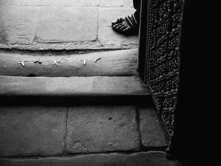A man stands in front of the entrance to Kumari house in Durbar Square, Kathmandu.の写真素材